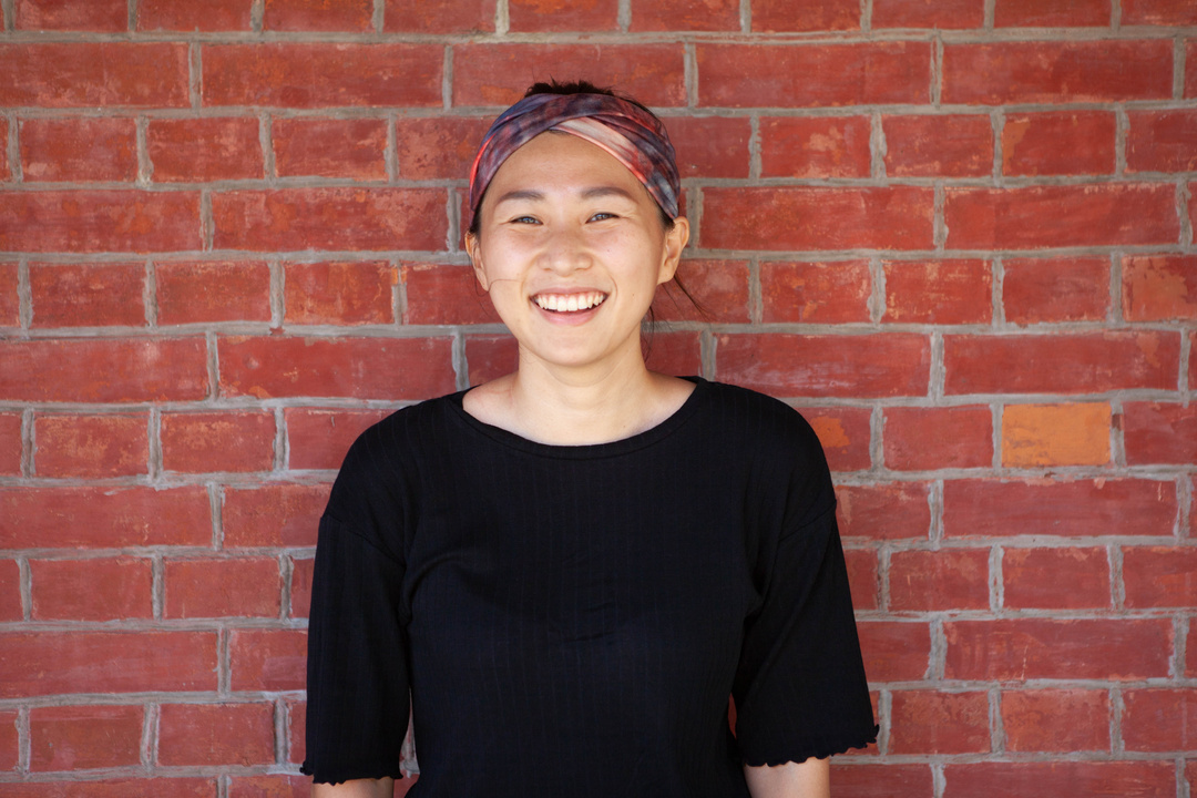 Close-Up Shot of a Woman in Black Top Smiling